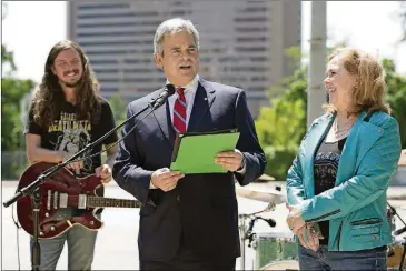  ?? JAY JANNER / AMERICAN-STATESMAN ?? Mayor Steve Adler reads a proclamati­on at City Hall during HAAM Day 2017 as HAAM executive director Reenie Collins and musician Ty Richards look on.