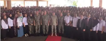  ??  ?? Liew (stand front row, ninth left), Mundaw (front, eighth left) pose with officials, ATM personnel and others during his visit to the Muara Tuang Camp yesterday.