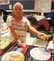  ?? LAUREN HALLIGAN - LHALLIGAN@TROYRECORD.COM ?? A woman serves Mexican cuisine at the 46th annual Festival of Nations, held Sunday at the Empire State Plaza Convention Center in Albany.