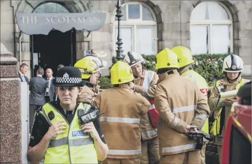  ?? Picture: Ian Georgeson ?? Emergency service workers gather outside The Scotsman hotel, where the couple were found on Thursday