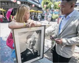  ?? Irfan Khan Los Angeles Times ?? SEI FUJII came to the U.S. in 1903 and earned a law degree from USC but could not practice law because of his race. He died in 1954. Above, Cindy Abrams has a photo of Fujii while talking to Jeffrey Gee Chin, who directed a film about him.