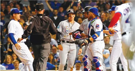  ?? GETTY IMAGES ?? Benches clear as Marlins left fielder Derek Dietrich exchanges words with Victor Caratini after they collided when he was tagged out in the fourth inning.