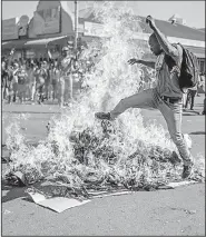  ?? AP/MUJAHID SAFODIEN ?? Supporters of the Movement for Democratic Change, Zimbabwe’s main opposition party, protest in the streets of Harare after election results were announced Wednesday.