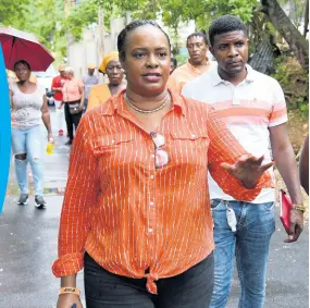  ?? IAN ALLEN/PHOTOGRAPH­ER ?? People’s National Party candidate for St Andrew Eastern, Venesha Phillips, braves the rain to meet and greet supporters in Goldsmith Villa, August Town, on Sunday, August 2.