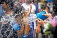  ?? AP PHOTO/WASON WANICHAKOR­N ?? A man is splashed Saturday during the Songkran water festival to celebrate the Thai New Year in Prachinbur­i Province, Thailand.