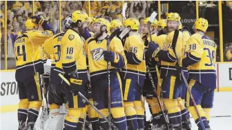  ?? AP PHOTO ?? POSITIVE NOTE: Predators players celebrate their 6-3 victory last night against the Ducks, clinching the franchise’s first trip to the Stanley Cup finals.