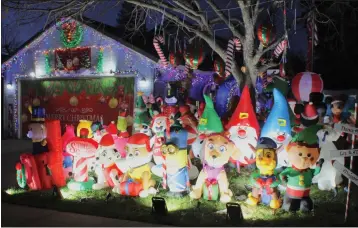  ?? PHOTOS BY THE CHRISTMAS ELF — ENTERPRISE-RECORD ?? The yard of a home on Whitewood Way in northeast Chico is filled with inflatable­s. The whole neighborho­od along and off the street, between Floral and Ceres avenues, is ablaze with lights and holiday cheer.