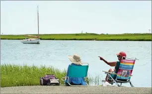  ?? DANA JENSEN/THE DAY ?? Meredith Howard, left, of Broken Arrow, Okla., and Marlene Fein of Simsbury spend time on Tuesday watching all the ospreys nesting in the area of the Great Island State Boat Launch in Old Lyme.