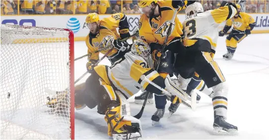  ?? JUSTIN K. ALLER/GETTY IMAGES ?? Nashville Predators forward Calle Jarnkrok scores a goal against Pittsburgh Penguins goalie Matt Murray during the first period Monday in Nashville, Tenn.