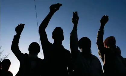  ?? Photograph: Jeff Dean/AFP/Getty Images ?? Friends, family and community members hold up their phones during a candleligh­t vigil held in Krannert Park in Indianapol­is, Indiana, to remember the victims of a mass shooting at a local FedEx facility.