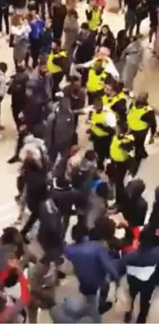  ??  ?? Brawl: Police break up a fight in East London yesterday