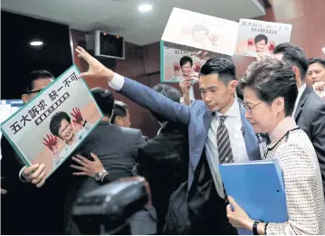  ?? REUTERS ?? Hong Kong Chief Executive Carrie Lam arrives to deliver her annual policy address, as lawmakers shout protests, at the Legislativ­e Council in Hong Kong, China, yesterday.