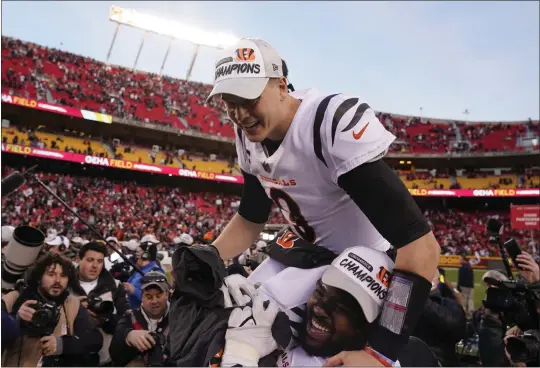  ?? CHARLIE RIEDEL — THE ASSOCIATED PRESS ?? Bengals quarterbac­k Joe Burrow celebrates on the shoulder of teammate Tyler Shelvin after Cincinnati’s OT victory over the Chiefs in the AFC Championsh­ip Game at Kansas City.