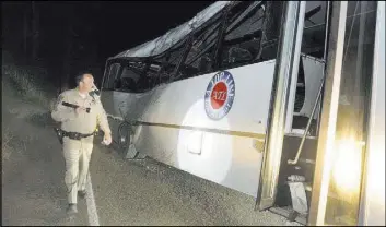  ?? CRAIG KOHLRUSS/THE FRESNO BEE VIA AP ?? A California Highway Patrol officer views the scene of a fatal accident Sept. 24 after a tour bus carrying students from China hit a tree near Yosemite National Park outside the Sierra Nevada town of Oakhurst, Calif. Traffic fatalities on the nation’s...