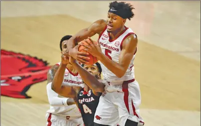  ?? Associated Press ?? Rebound: Georgia's Andrew Garcia (4) and Arkansas' Moses Moody (5) fight for a rebound during the first half of an NCAA college basketball game Saturday in Fayettevil­le. Arkansas plays at LSU tonight.