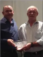  ??  ?? Nicky Cousins receiving the Taghmon Golf Society’s Captain’s prize from Seamus McLoughlin.