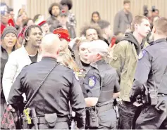  ??  ?? Police officers confront Black Lives Matter activists that are disrupting the Sacramento city council meeting in Sacramento. — AFP photo