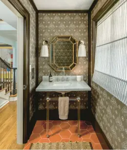  ?? KELLY KISH PHOTOGRAPH­Y ?? A powder room designed by Peter Spalding features Katie Ridder’s Oiseau wallpaper, barnhued tile, contempora­ry lighting and a sleek marble sink.