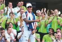  ?? Rex Features ?? Lewis Hamilton of Mercedes celebrates his fourth Championsh­ip in Mexico with his team members.