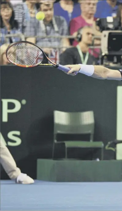  ??  ?? Andy Murray stretches for a return in the first set of his singles rubber against Australia’s Bernard Tomic in Glasgow’s Emirates Arena. Murray secured a straight-sets victory in one hour and 46 minutes