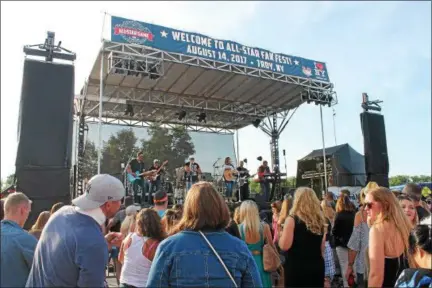  ?? PHOTOS BY LAUREN HALLIGAN — LHALLIGAN@DIGITALFIR­STMEDIA.COM ?? Local country act Skeeter Creek performs during All Star FanFest, a free event held ahead of the 2017New York-Penn League All-Star Game on Monday night in Troy’s Riverfront Park.