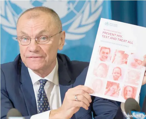 ??  ?? Cottfried Hirnschall, director of the World Health Organisati­on’s Department of HIV and Global Hepatitis Programme, shows a new progress report on HIV at a press conference in Geneva, Switzerlan­d, on Tuesday.