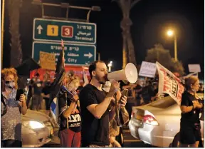  ?? (AP/Maya Alleruzzo) ?? Protesters block an entrance to Ben Gurion Airport in Tel Aviv on Sunday. Israeli Prime Minister Benjamin Netanyahu and his family were expected to fly with an Israeli delegation to the U.S. for a ceremony with the United Arab Emirates on the same day lockdowns were announced for the country.