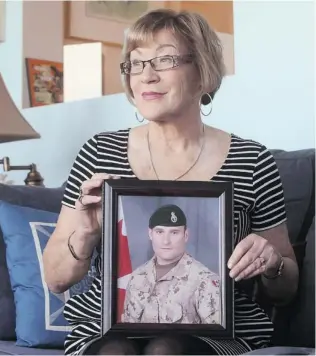  ?? MIKE DEMBECK/ THE CANADIAN PRESS ?? Above, Anne Snyder poses with a photo of her son Jonathan at her home in Head of Jeddore, N. S. Jonathan, 26, was a member of Princess Patricia’s Canadian Light Infantry who was killed while on a night patrol in the Zhari district of Kandahar province....