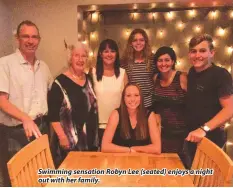  ??  ?? Swimming sensation Robyn Lee (seated) enjoys a night out with her family.