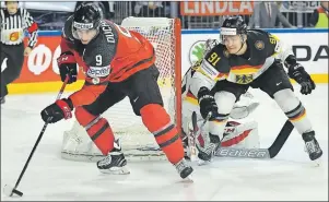  ?? AP PHOTO ?? Canada’s forward Matt Duchene, left, and Germany’s defender Moritz Mueller battle for the puck at the Ice Hockey World Championsh­ips quarterfin­al match between Canada and Germany in the LANXESS arena in Cologne, Germany, on Thursday.