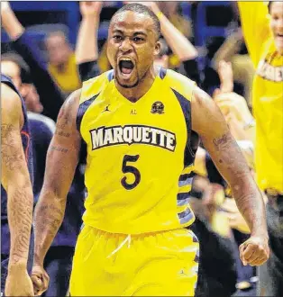  ?? ASSOCIATED PRESS FILE PHOTO/JEFFREY PHELPS ?? In this Jan. 1, 2013 file photo, Marquette’s Junior Cadougan reacts after making a buzzer-beating three-pointer at the end of regulation to tie an NCAA Division 1 men’s basketball game against Connecticu­t in Milwaukee. Marquette would go on to win in overtime. Cadougan, who has also played for the Canadian men’s national team, has signed a contract with the NBL Canada’s St. John’s Edge.