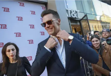  ?? NICOLAUS CZARNECKI / HERALD STAFF ?? Tom Brady arrives on Boylston Street for the grand opening of TB12.