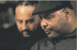  ??  ?? A grieving Marc McCoy (right) pauses while rememberin­g his younger brother, Willie McCoy, a 21-year-old budding local rapper.