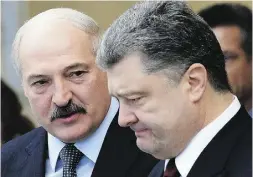  ?? MAXIM MALINOVSKY / AFP / GETTY IMAGES ?? Belarusian President Alexander Lukashenko, left, speaks with Ukraine’s Petro Poroshenko Thursday after the summit.