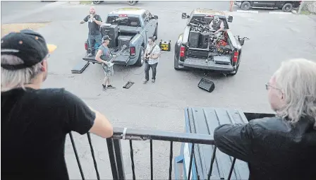  ?? DAVID BEBEE WATERLOO REGION RECORD ?? Patrons of Chainsaw watch members of Wicked Truth — Matthew Blunt, left, Wayne Unruh, Brent Perez and Anthony Nalli — perform in the back parking lot of the Waterloo bar.