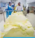  ??  ?? This file photo taken on March 17, 2015 shows workers extracting butter out of a wooden churn in Echire in central western France. —AFP