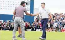  ?? PHOTO: REUTERS ?? Well done . . . New Zealander Ryan Fox (left) and Scotland’s Russell Knox shake hands at the end of the Irish Open in Ballyliffe­n yesterday. Knox won on the first hole of a playoff to claim the title.