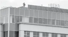  ??  ?? A worker stands on top of the View Royal Surgical Centre, set to open in early May near Victoria General Hospital.