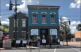  ?? SARAH FRANKS / STAFF ?? Protesters with Miami Valley Abolitioni­st and other Dayton residents gather outside the Ghostlight Coffee shop Saturday.