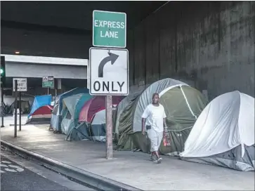  ?? Irfan Khan Los Angeles Times ?? AN ENCAMPMENT on 39th Street under the 110 Freeway in L.A. President Trump’s budget could upend the city’s housing efforts. “There are a lot of moving parts, none of them good,” said L.A.’s housing authority chief.