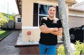  ?? CARLINE JEAN/SOUTH FLORIDA SUN SENTINEL ?? Nathan Beauchamp stands in front of his new home in Pembroke Pines on Thursday. Beauchamp got a mortgage loan from Tropical Financial Credit Union shortly before the rates crossed over 3%.