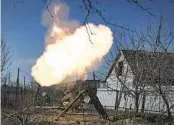  ?? LIBKOS AP ?? Ukrainian soldiers fire a mortar at Russian positions on the front line in the Donetsk region on Sunday.