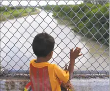  ?? Mark Mulligan / Houston Chronicle ?? Fiveyearol­d Jesus Bindel Rodriguez, from Honduras, waits on the Mexican side of the middle of the Brownsvill­e & Matamoros Express Internatio­nal Bridge for the fourth day in a row hoping for his family to be able to pass together into the United States to seek asylum last year in Brownsvill­e, Texas. Jesus, along with his parents and three siblings, was hoping to escape violent threats against the family in their hometown in Honduras.