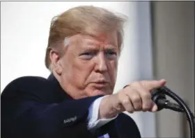  ?? AP PHOTO/PABLO MARTINEZ MONSIVAIS ?? President Donald Trump points to a member of the media while taking questions after speaking during an event in the Rose Garden at the White House to declare a national emergency in order to build a wall along the southern border Friday in Washington.