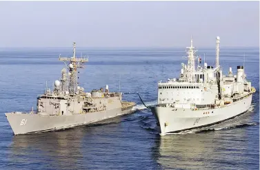  ?? MCPL BRIAN WALSH, DGPA / J5PA COMBAT CAMERA ?? HMCS Preserver, right, refuels the U.S. Navy frigate USS Ingraham. Vice-Admiral Mark Norman announced the decommissi­oning of the Preserver in 2014, and then became embroiled in controvers­y surroundin­g its replacemen­t.