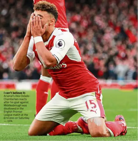  ??  ?? I can’t believe it: Arsenal’s Alex OxladeCham­berlain reacts after his goal against Middlesbro­ugh was disallowed in the English Premier League match at the Emirates on Saturday. — EPA