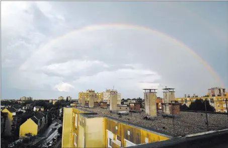  ?? Gyorgy Varga ?? A rainbow appears in the sky after a heavy downpour Tuesday in Nagykanizs­a, Hungary. The Associated Press