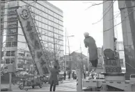  ?? LIU MANQING / FOR CHINA DAILY ?? Workers remove a giant sign of a hotel in downtown Beijing last month that is deemed to have violated relevant regulation­s.