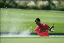  ?? DANTE CARRER — THE ASSOCIATED PRESS ?? Tiger Woods hits from a bunker on the 17th hole during the final round of the Hero World Challenge golf tournament at Albany Golf Club in Nassau, Bahamas last weekend.