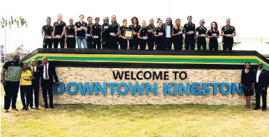  ??  ?? Jamaica’s senior women’s football team, coaching staff and government officials pose with the key to the city of Kingston at a presentati­on ceremony in downtown Kingston, yesterday.